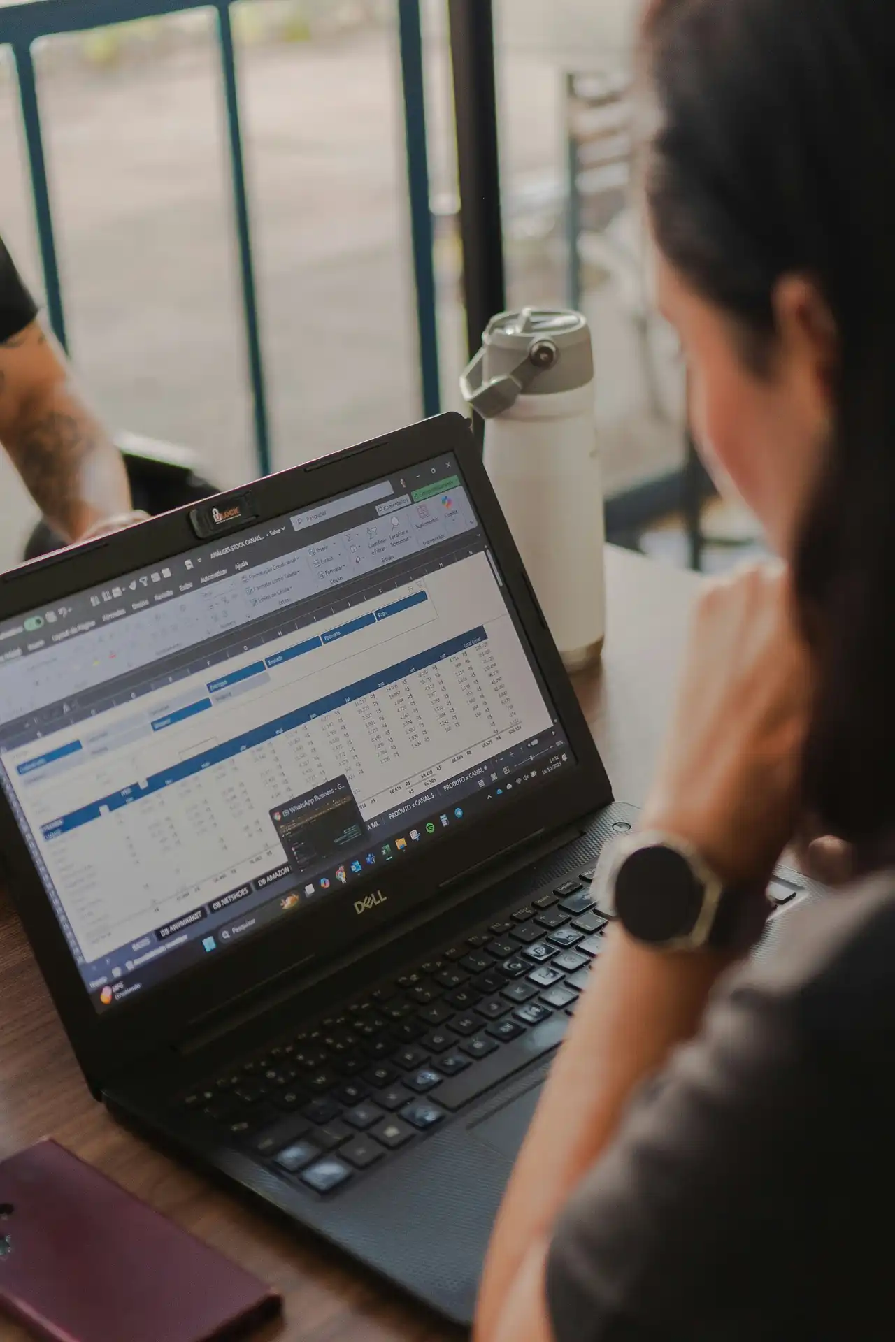 Employee reviewing total land cost statistics and benchmarks in an office setting